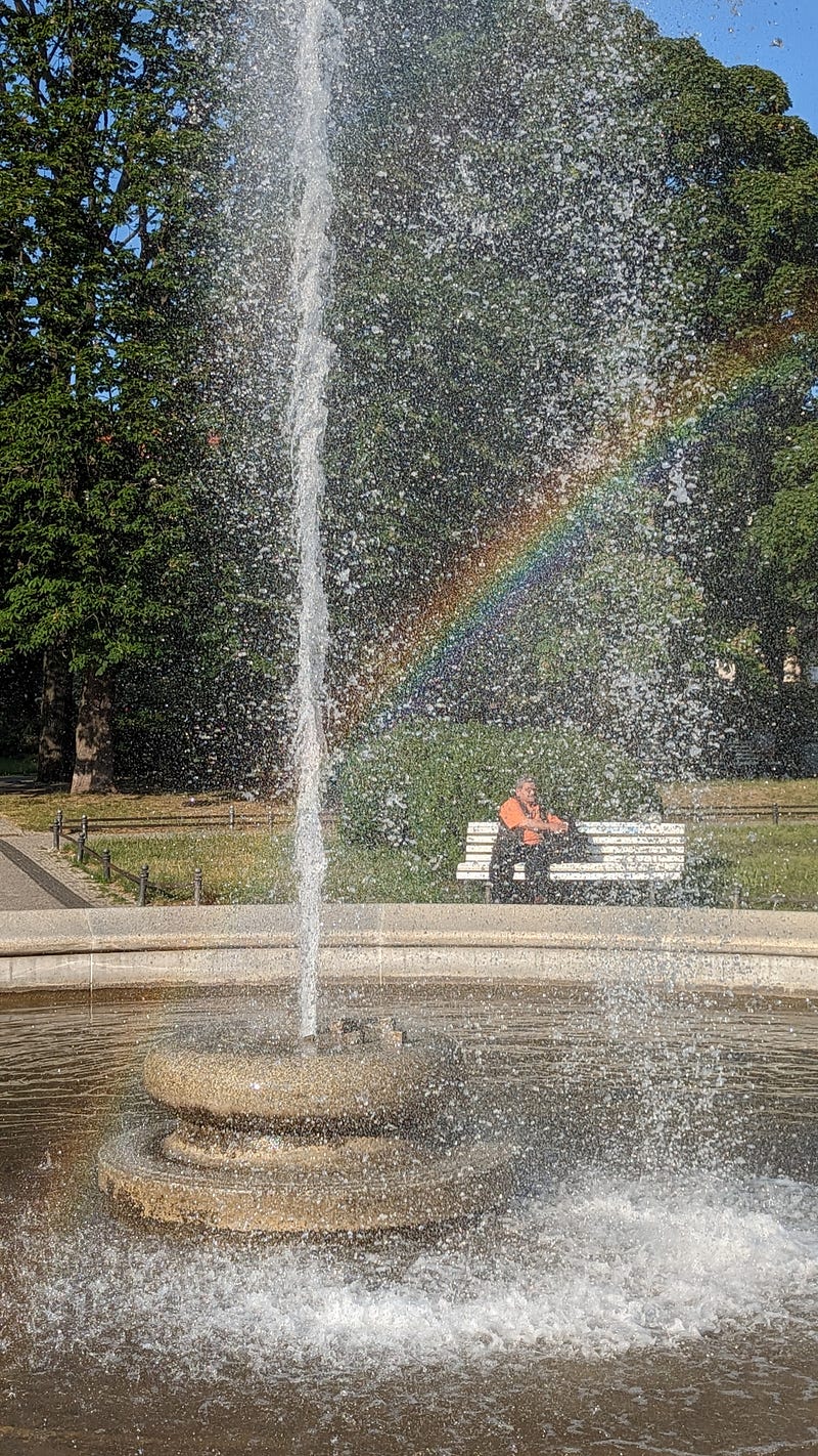 A beautiful rainbow forming in a fountain